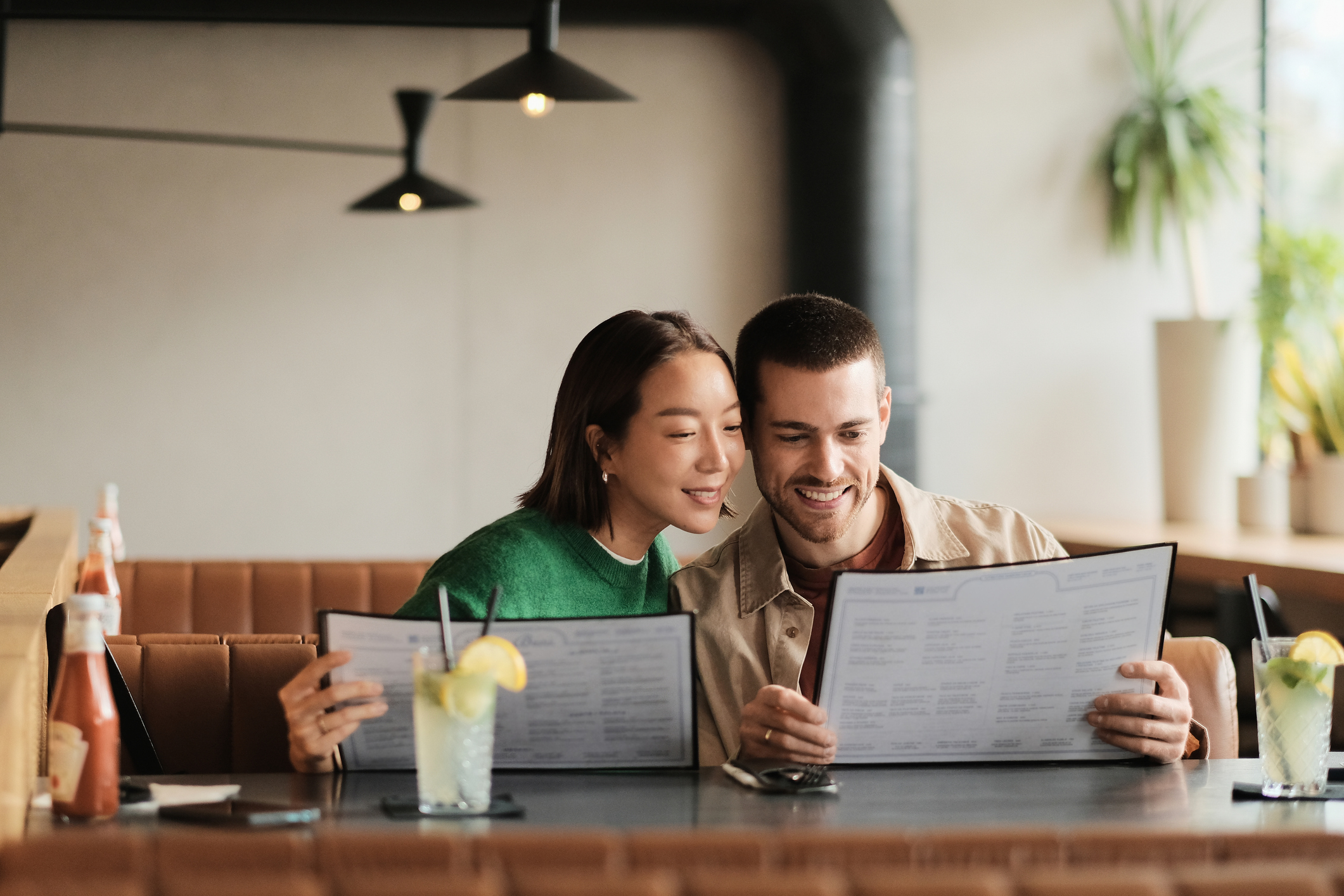 Joyful Married Couple Enjoying a Warm Dining Experience at a Modern Restaurant