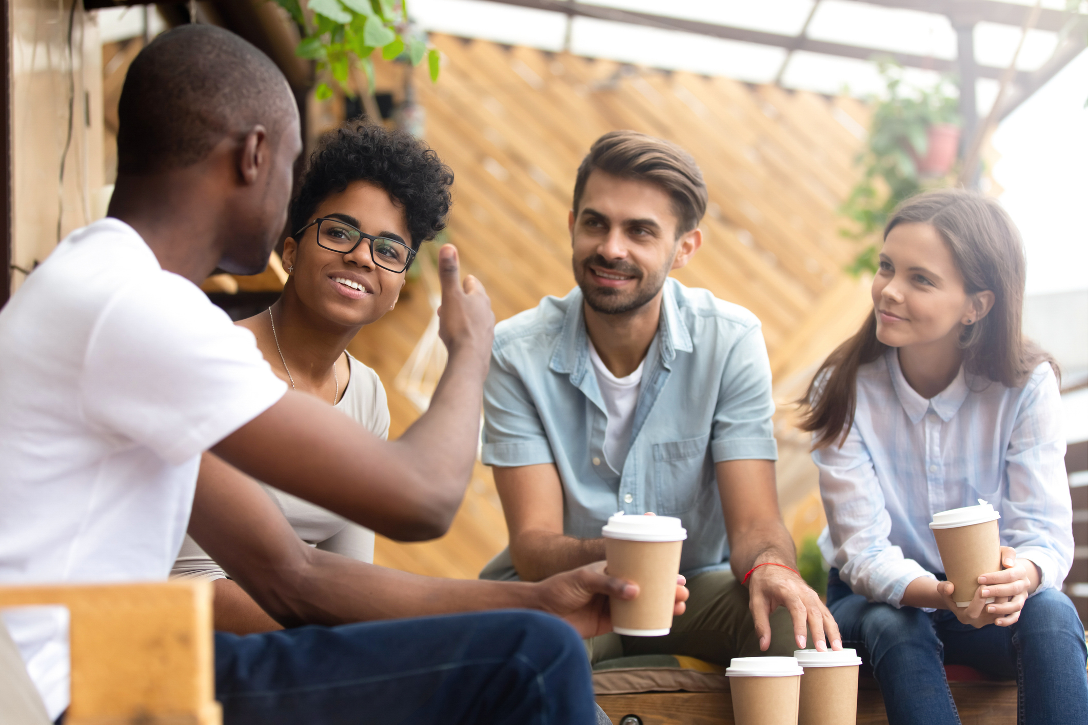 man talking to friends in cafe