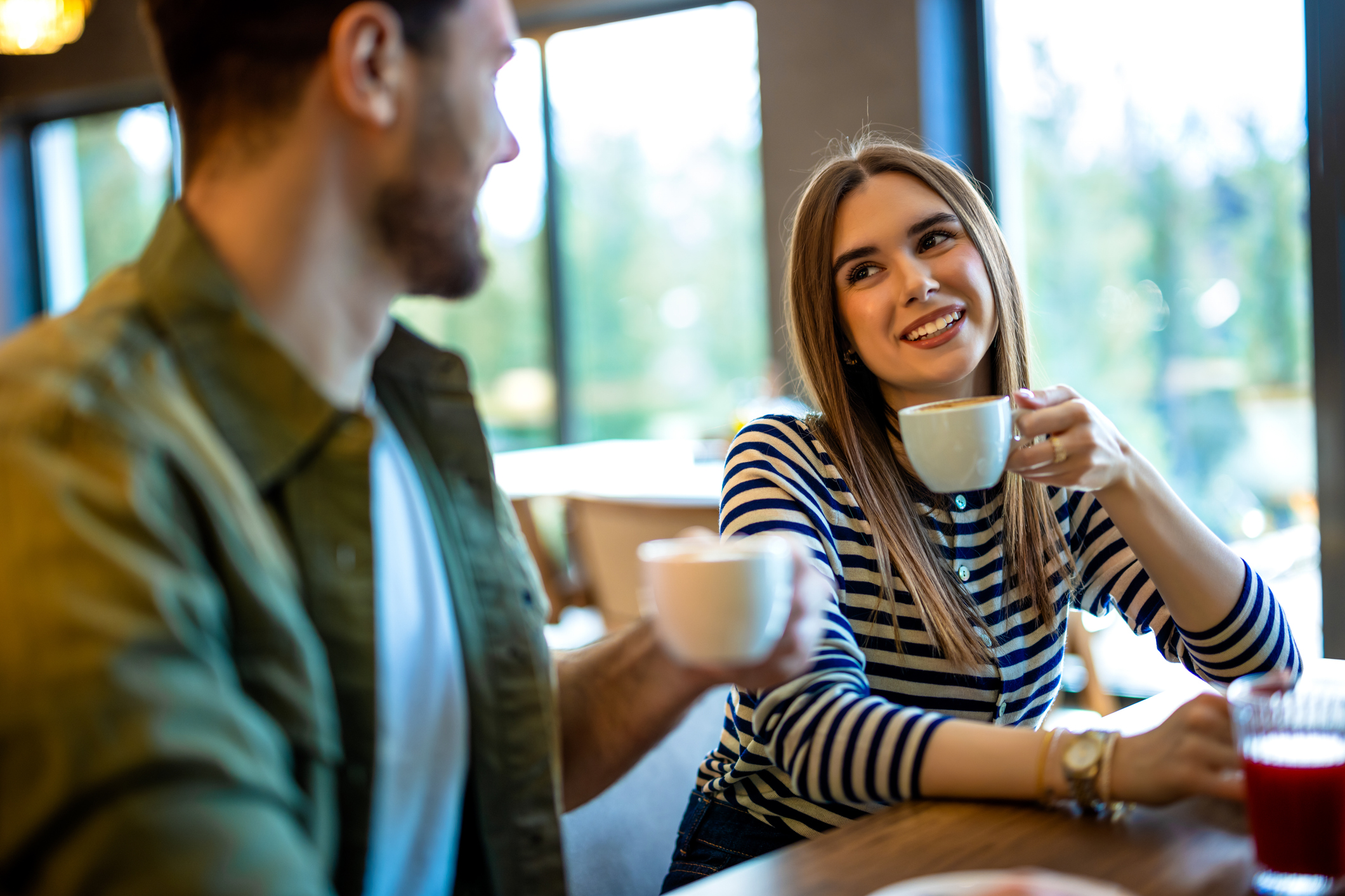man and a woman sharing coffee in a restaurant