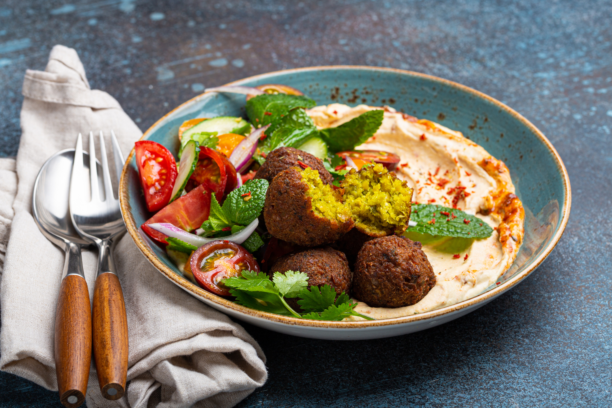 Close up of meal with falafel, hummus, vegetables salad