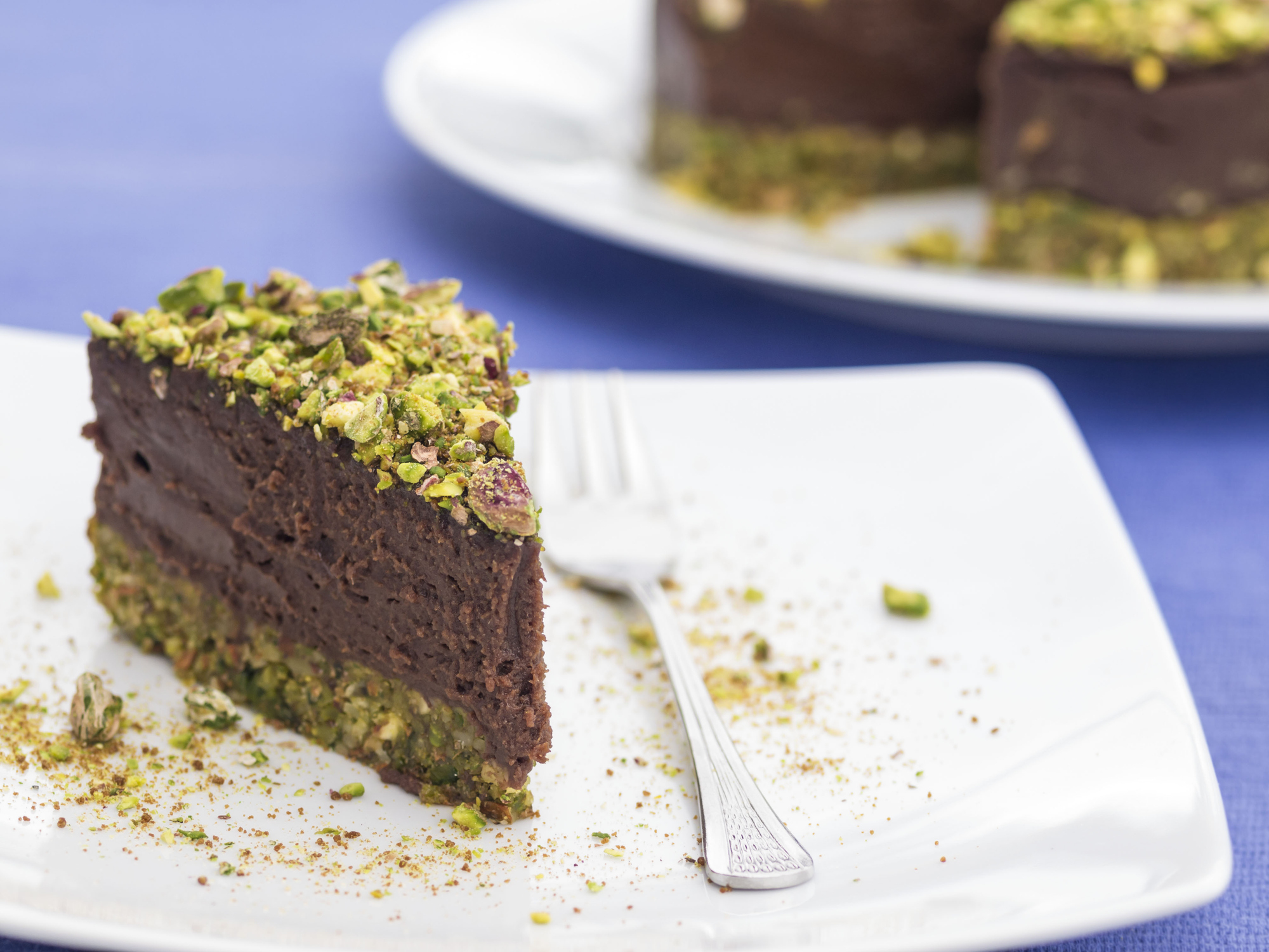 Piece of delicious raw vegan pistachio chocolate cake